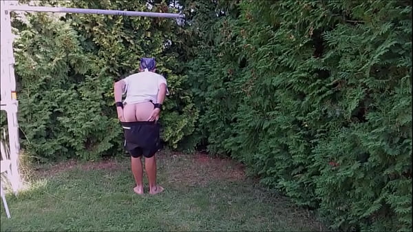 naked pathetic slave exposed in penis cage on outdoor party, striptease with humiliating body writing, BDSM CBT