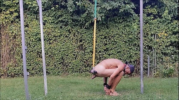 naked pathetic slave exposed outdoor, handcuffed, balls in humbler stretched, BDSM CBT